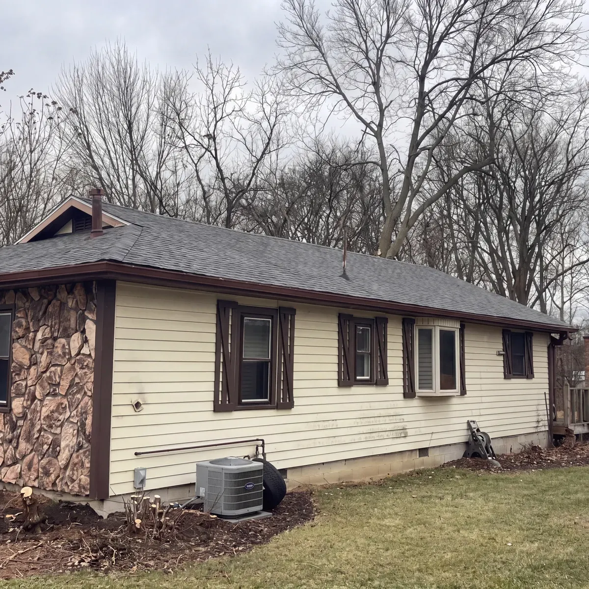 Ranch home with a new shingle roof and gutters installed by GNG