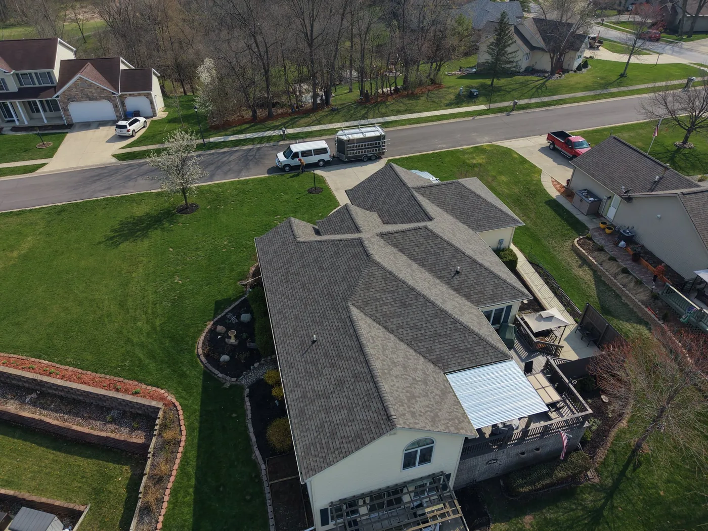 Aerial drone view of a completed roof installation on a custom home near Grabill, Indiana