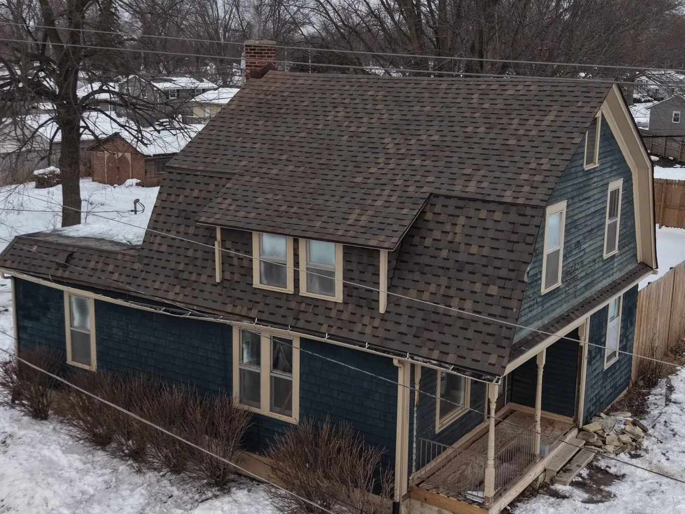 Historic two-story home with new dark asphalt shingle roof replacement in Grabill, Indiana